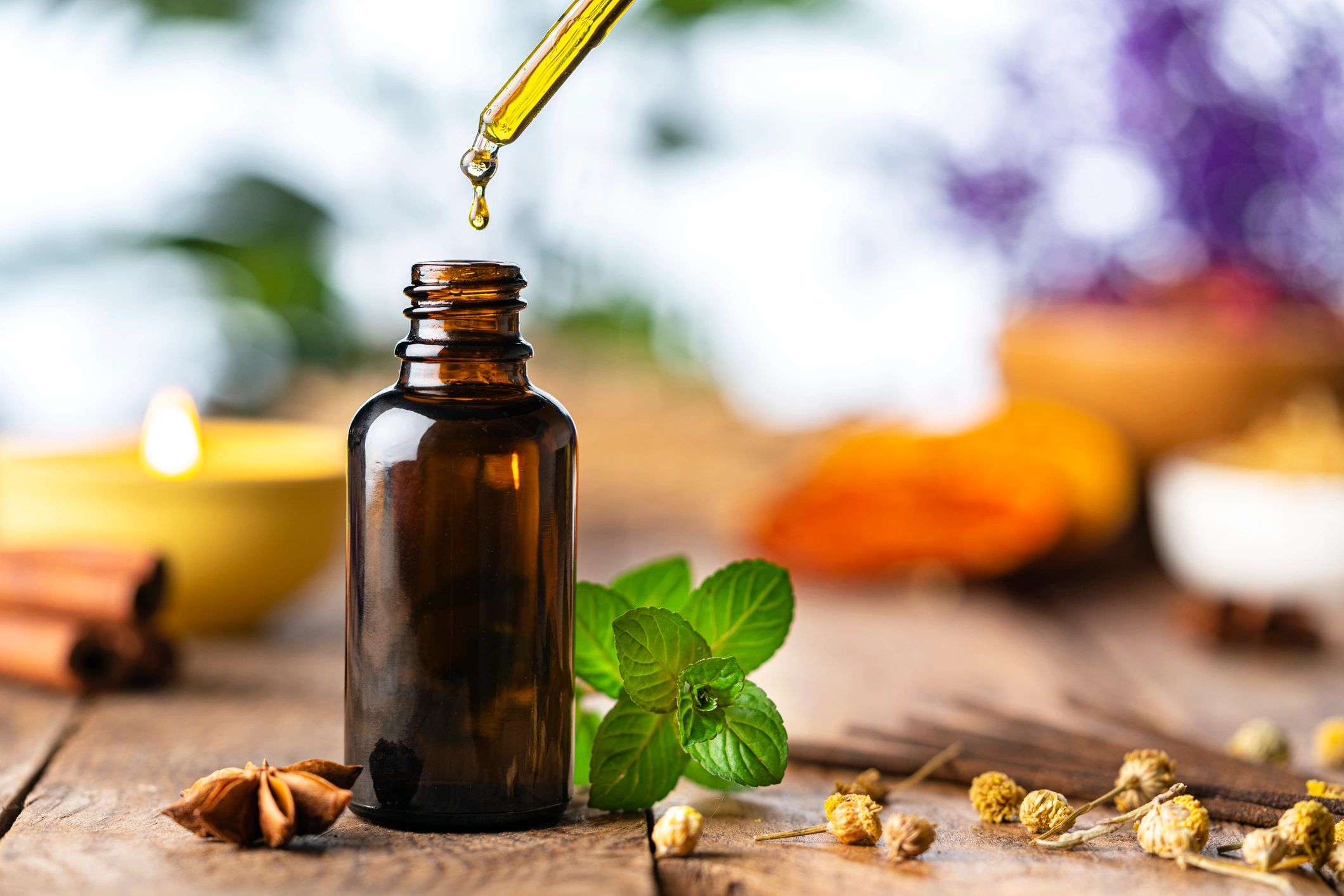 Essential oil bottle on a wooden table in a spa setting