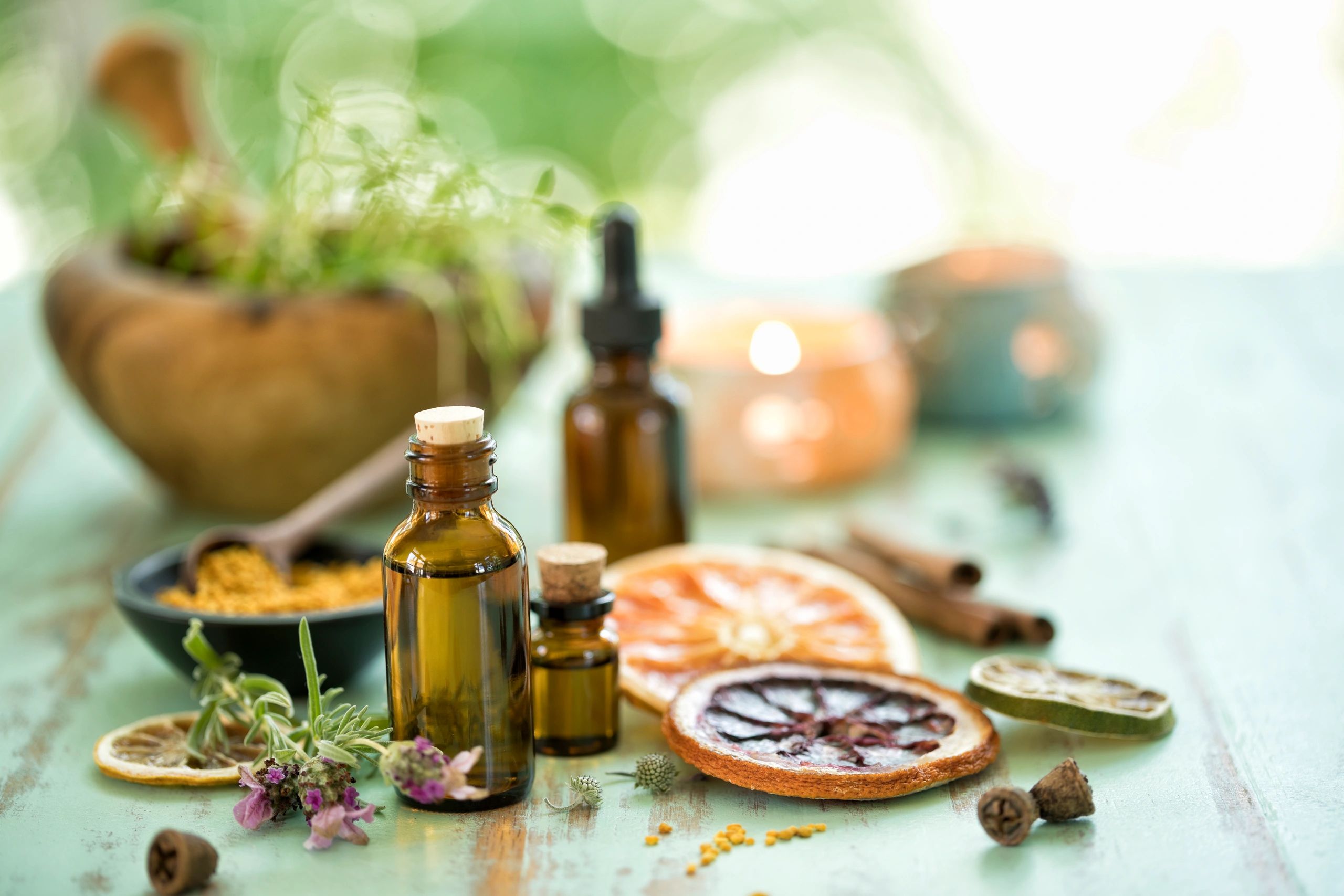 Amber glass bottles with fresh herbs in a calm spa setting
