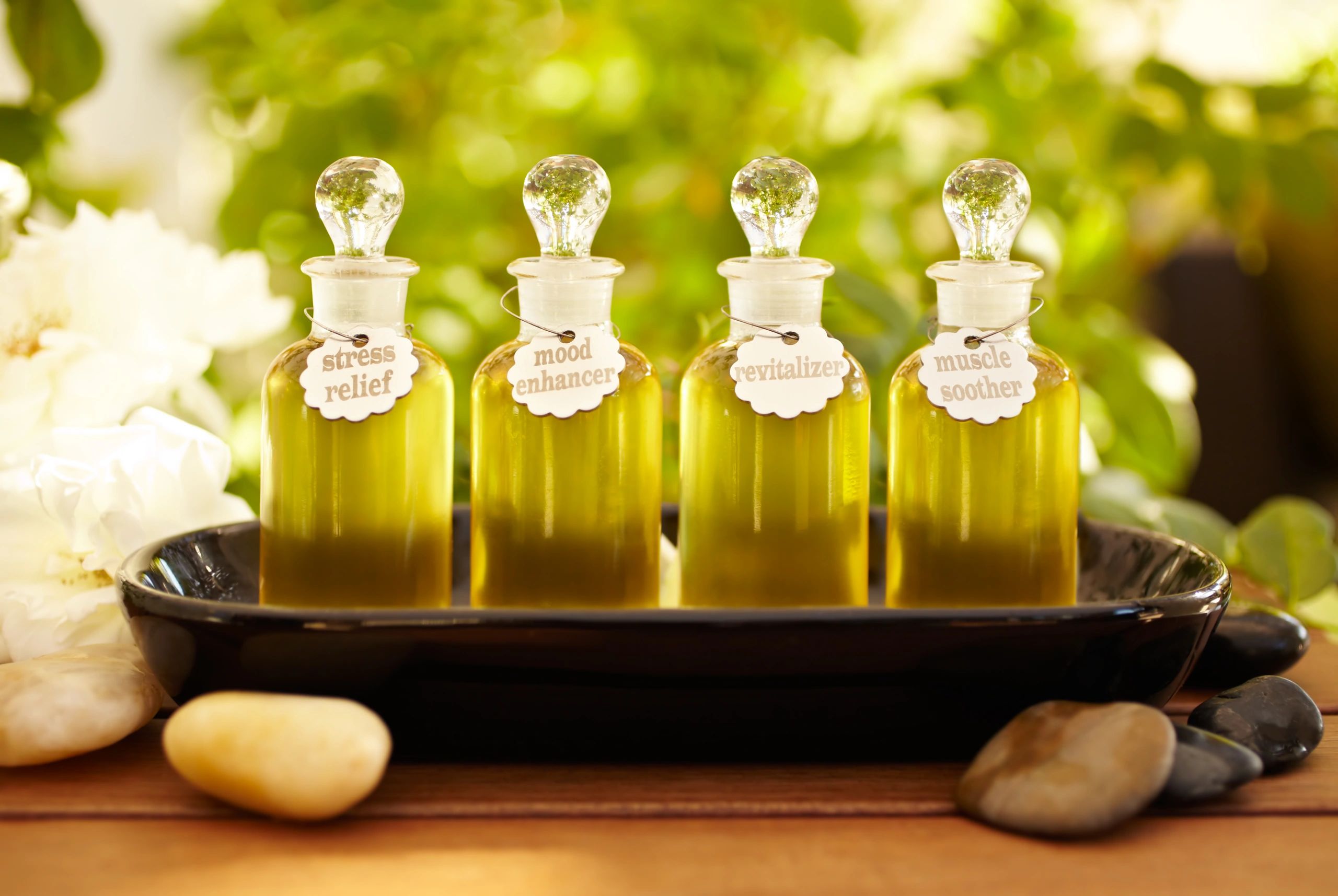 Massage oil bottles and herbs in a calming spa setting