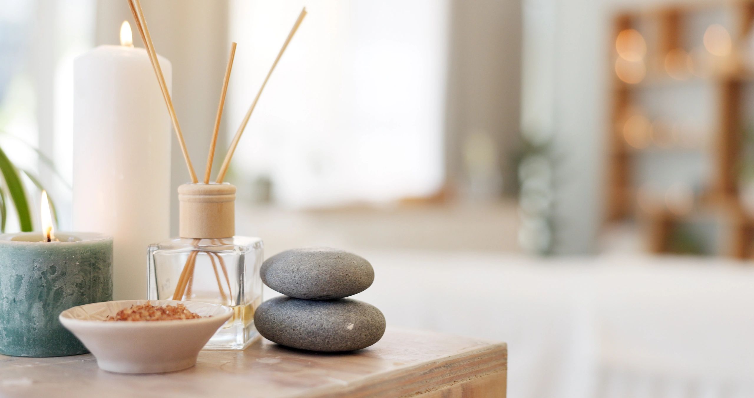 Spa stones and candle creating a warm herbal apothecary atmosphere